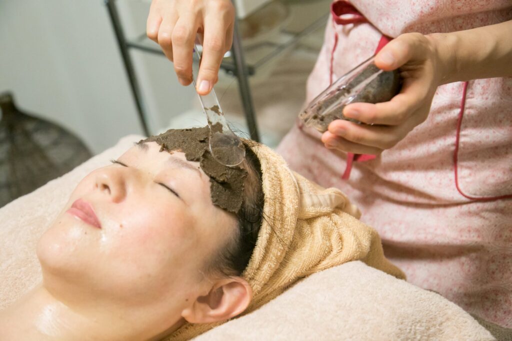 肌状態に合わせてハーブを調合し、額に丁寧に塗布するフェイシャル施術。自然の恵みで肌本来の力を引き出す。